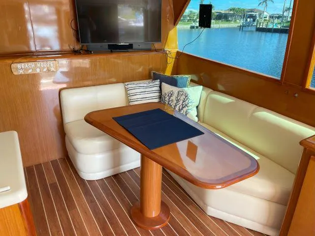 Slide: The Image of Interior of 1999 Viking 50 Convertible yacht with cozy seating and waterfront view. - 32