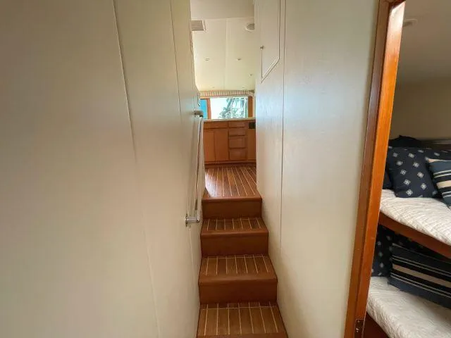 Slide: The Image of Interior hallway of 1999 Viking 50 Convertible yacht with wooden stairs and cozy cabin. - 33