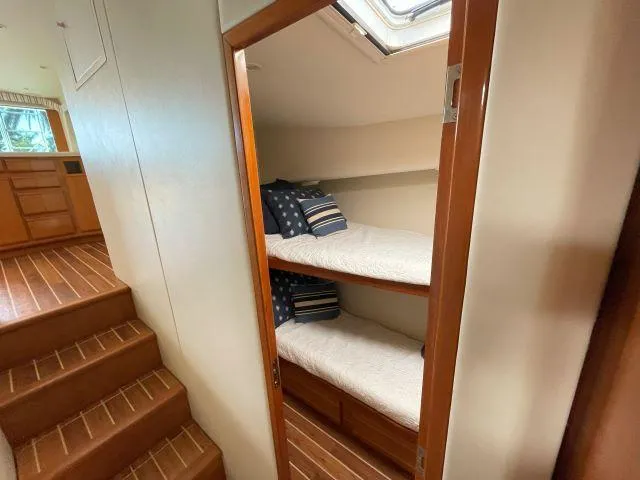 Slide: The Image of Bunk beds in 1999 Viking 50 Convertible yacht cabin with wooden flooring. - 34