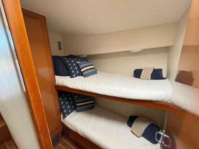 Slide: The Image of Bunk beds in 1999 Viking 50 Convertible yacht cabin with nautical-themed bedding. - 35