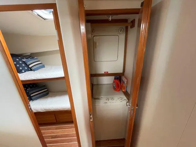 Slide: The Image of Laundry area and bunk beds in 1999 Viking 50 Convertible yacht interior. - 36