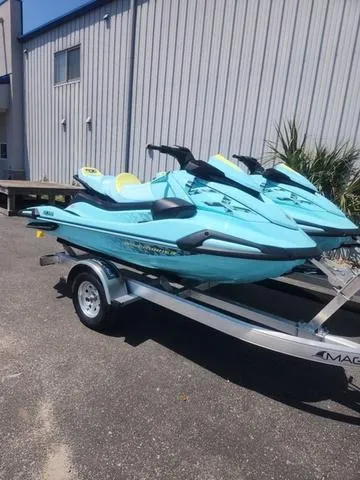 Slide: The Image of 2025 Yamaha WaveRunner VX Limited Ho in vibrant teal color, side view. - 1