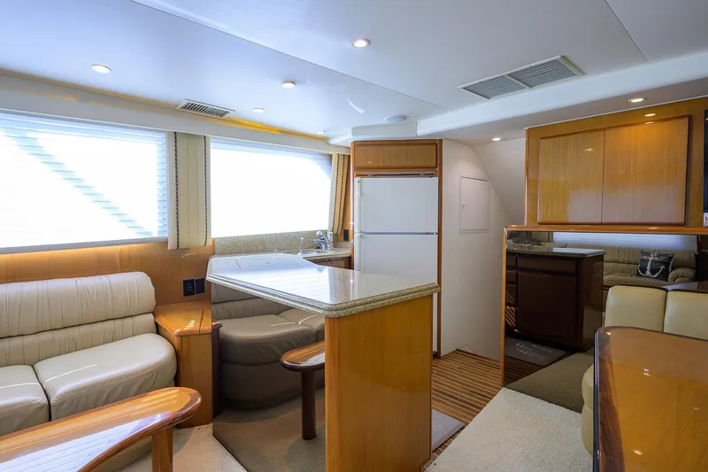Slide: The Image of Interior of 2000 Viking 50 Convertible yacht with modern kitchen and seating area. - 11