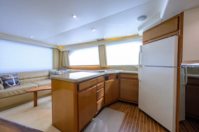 Slide: The Image of Interior of 2000 Viking 50 Convertible yacht with kitchen and seating area. - 12