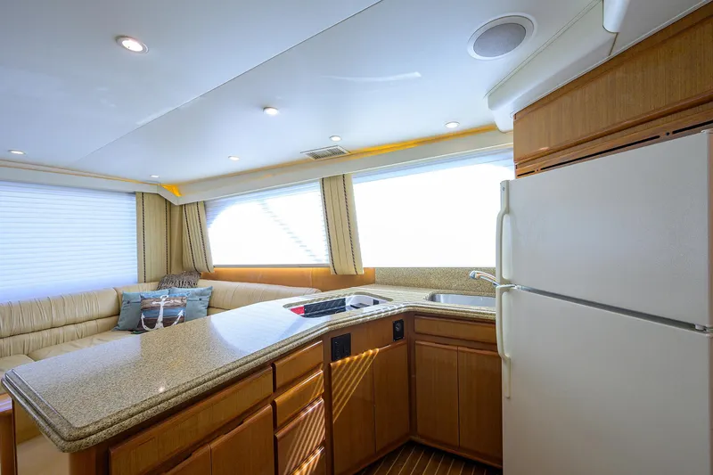Slide: The Image of Interior of 2000 Viking 50 Convertible yacht with kitchen and seating area. - 13