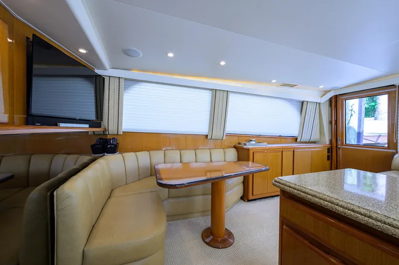 Slide: The Image of Interior of 2000 Viking 50 Convertible yacht with beige seating and wooden accents. - 14