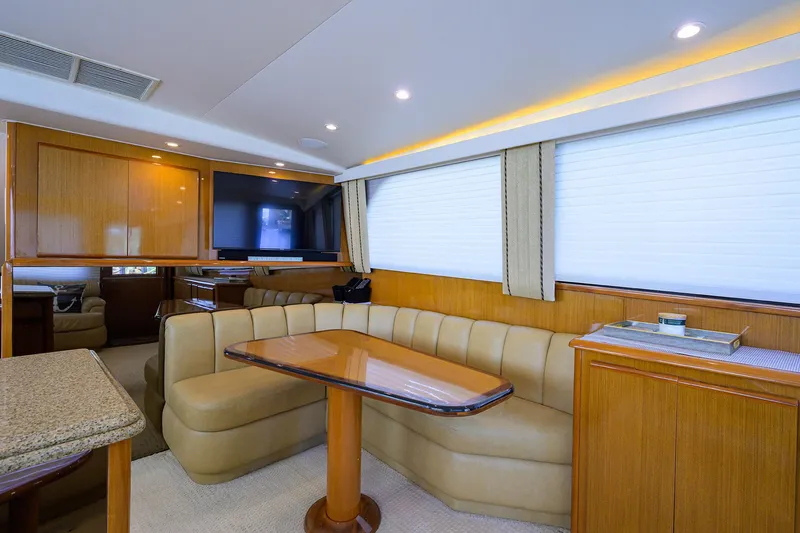 Slide: The Image of Luxurious interior of 2000 Viking 50 Convertible yacht with elegant seating and dining area. - 15