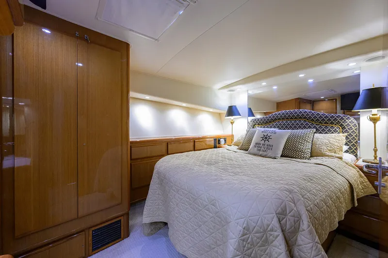Slide: The Image of Luxurious bedroom interior of 2000 Viking 50 Convertible yacht with elegant bedding and lighting. - 16