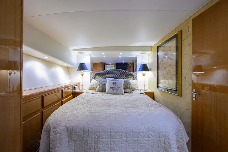 Slide: The Image of Luxurious bedroom interior of 2000 Viking 50 Convertible yacht with elegant bedding and lighting. - 17