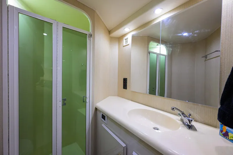 Slide: The Image of Bathroom interior of 2000 Viking 50 Convertible yacht with shower and sink. - 19