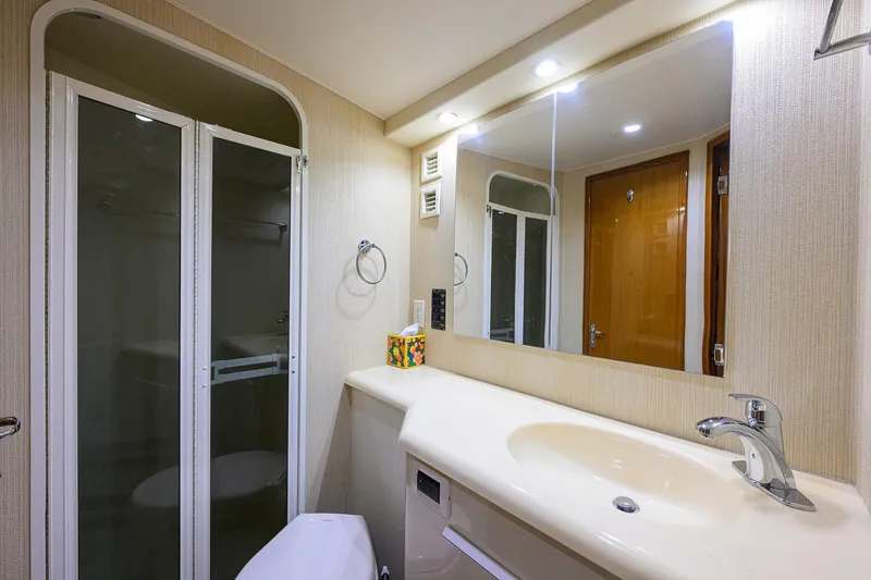Slide: The Image of Bathroom interior of 2000 Viking 50 Convertible yacht, featuring shower and sink. - 21