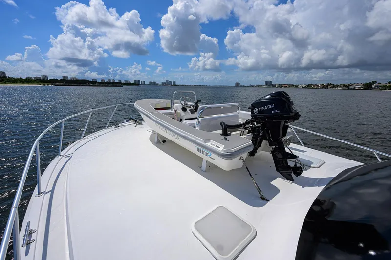 Slide: The Image of 2000 Viking 50 Convertible yacht on water, clear sky, and scenic shoreline. - 29