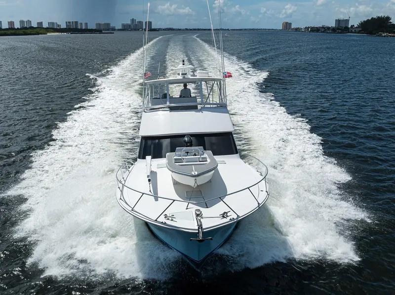 Slide: The Image of 2000 Viking 50 Convertible yacht cruising on open water, leaving a wake behind. - 3