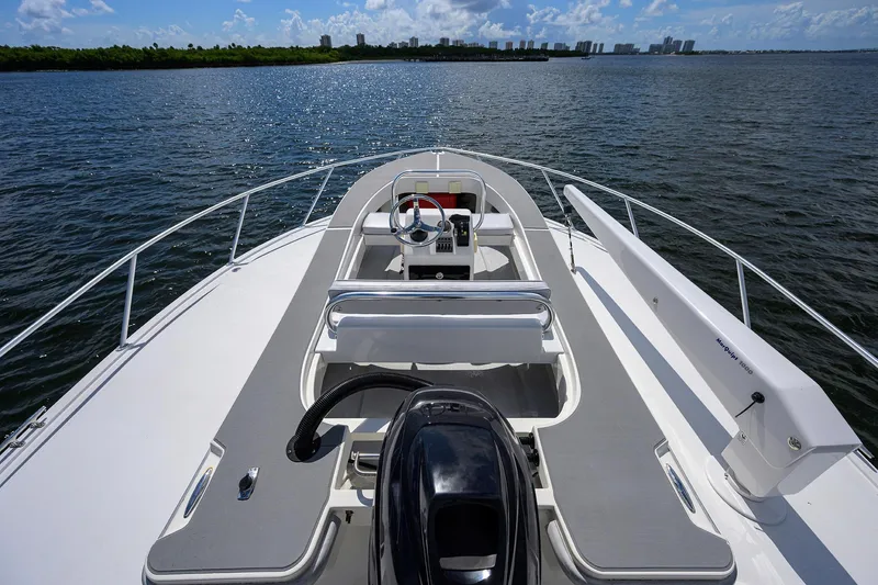 Slide: The Image of 2000 Viking 50 Convertible yacht on open water, showcasing sleek deck design and steering console. - 30