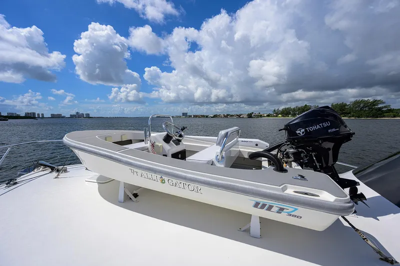 Slide: The Image of Small boat on Viking 50 Convertible yacht, 2000 model, with Tohatsu outboard motor, under blue sky. - 32