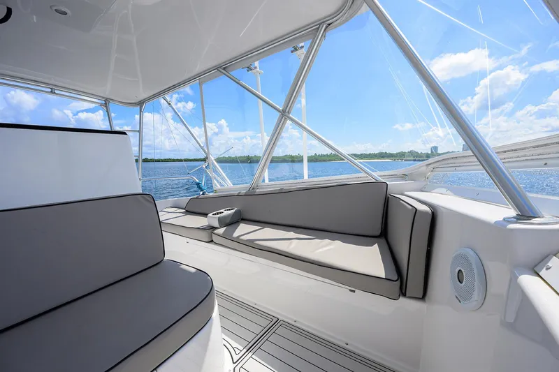Slide: The Image of 2000 Viking 50 Convertible yacht interior with cushioned seating and ocean view. - 33