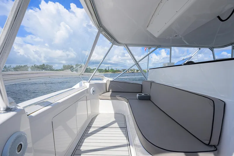 Slide: The Image of 2000 Viking 50 Convertible boat interior with cushioned seating and ocean view. - 35