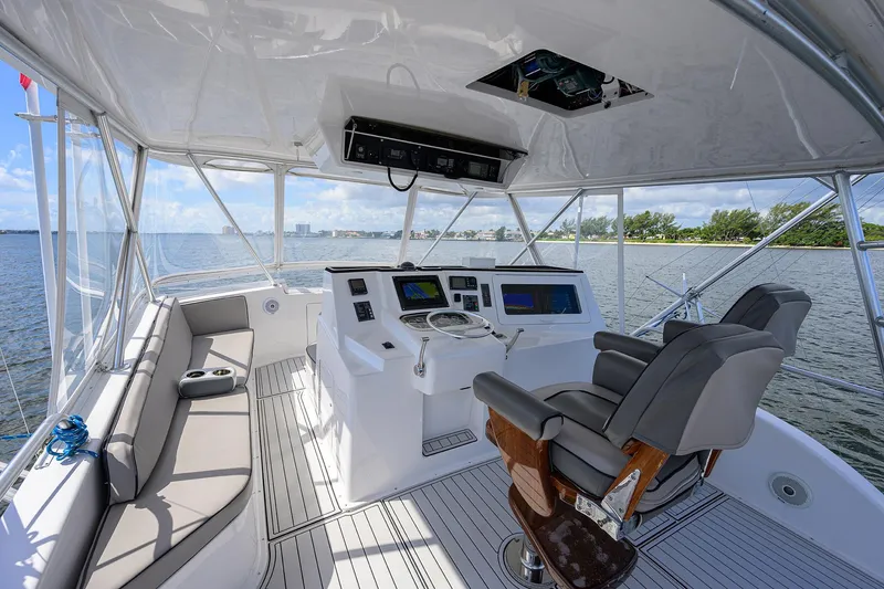 Slide: The Image of Helm of 2000 Viking 50 Convertible yacht with modern controls and seating. - 36