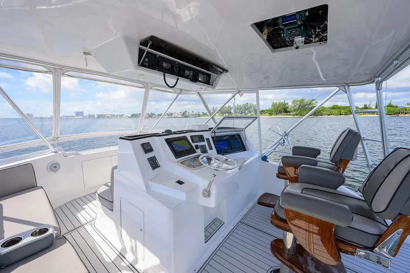 Slide: The Image of Helm of 2000 Viking 50 Convertible yacht with modern controls and seating. - 37