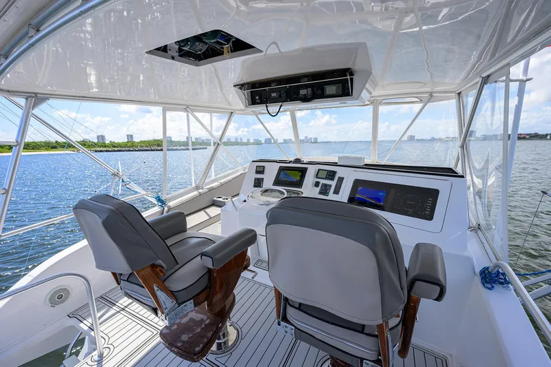 Slide: The Image of Helm of 2000 Viking 50 Convertible yacht with dual seats and navigation equipment. - 39