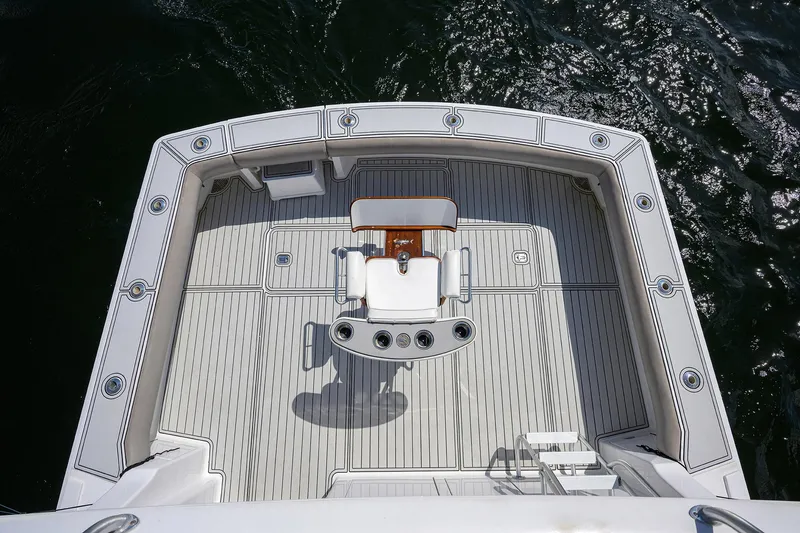 Slide: The Image of Viking 50 Convertible 2000 yacht deck, featuring a central chair and rod holders. - 42