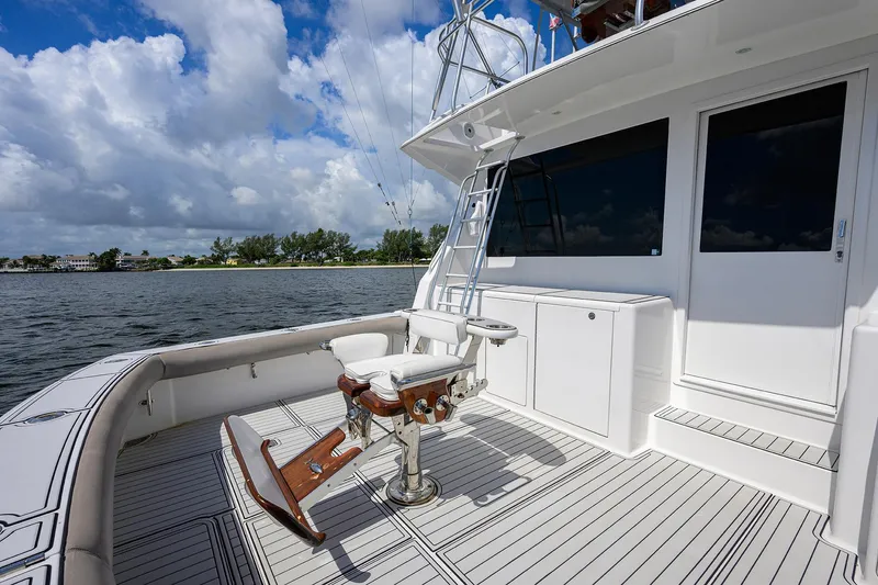 Slide: The Image of Viking 50 Convertible 2000 yacht deck with fishing chair, overlooking calm waters and cloudy sky. - 46