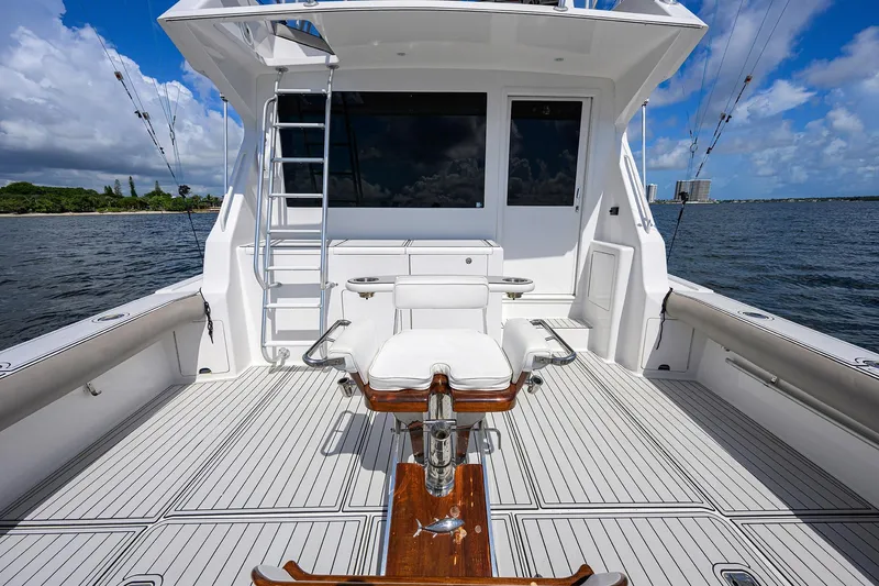 Slide: The Image of 2000 Viking 50 Convertible yacht deck with fishing chair, ocean view, and clear sky. - 47