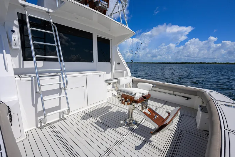 Slide: The Image of Viking 50 Convertible 2000 yacht deck with fishing chair, ocean view, and clear sky. - 48