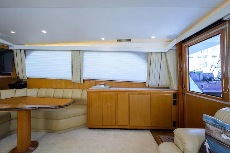 Slide: The Image of Interior of 2000 Viking 50 Convertible yacht with wood cabinetry and plush seating. - 7