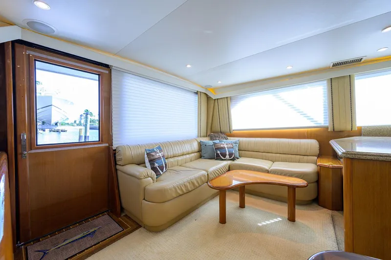Slide: The Image of Interior of 2000 Viking 50 Convertible yacht with beige leather seating and wooden accents. - 9