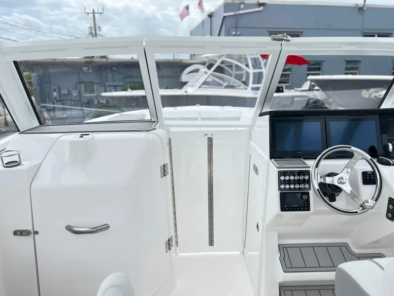 Slide: The Image of 2025 Sea Fox 288 Traveler boat cockpit with modern controls and sleek design. - 20