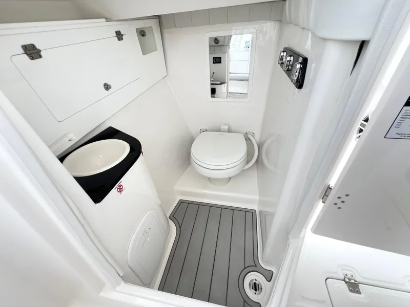Slide: The Image of 2025 Sea Fox 288 Traveler boat bathroom with toilet, sink, and storage cabinets. - 21