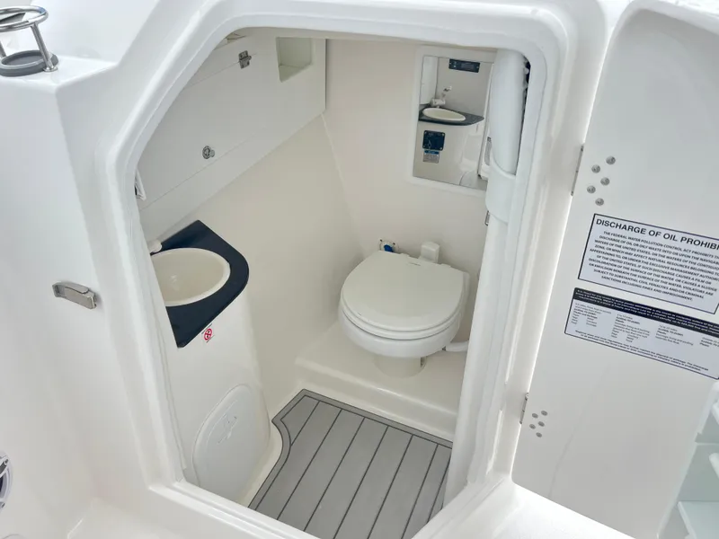 Slide: The Image of 2025 Sea Fox 288 Traveler boat bathroom with toilet, sink, and storage. - 22