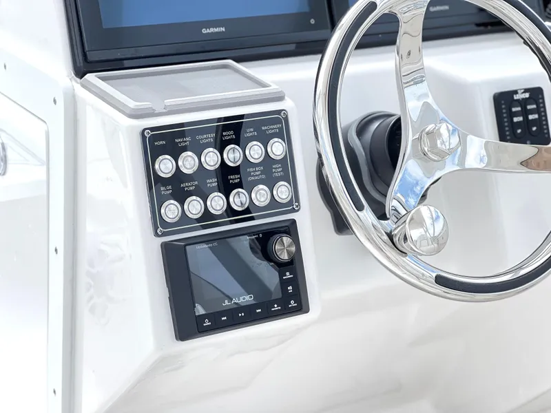 Slide: The Image of Control panel of 2025 Sea Fox 288 Traveler boat with steering wheel and electronic display. - 29