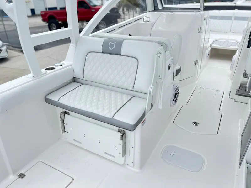 Slide: The Image of 2025 Sea Fox 288 Traveler boat interior with white cushioned seating and sleek design. - 40