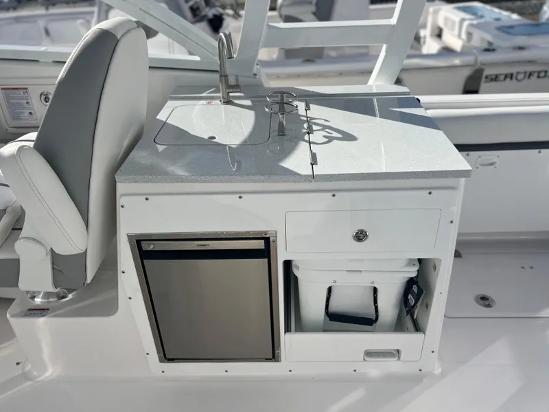 Slide: The Image of 2025 Sea Fox 288 Traveler boat interior with kitchenette, sink, and storage. - 46