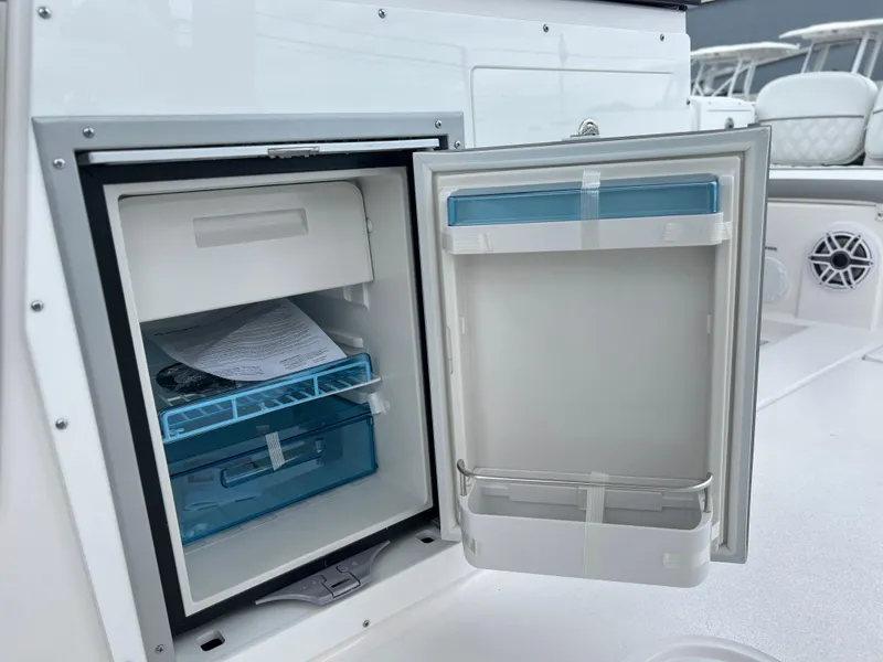 Slide: The Image of Open storage compartment on 2025 Sea Fox 288 Traveler boat, featuring organized interior shelves. - 48