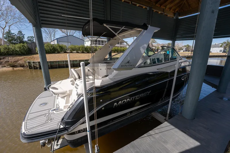 The Image of 2014 Monterey 295 Sport Yacht docked in a covered marina. - 0