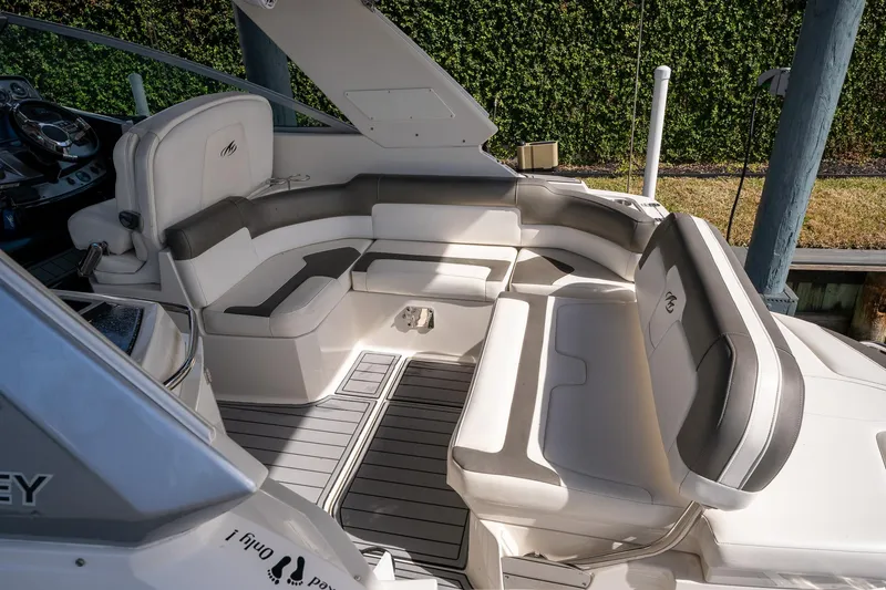 Slide: The Image of 2014 Monterey 295 Sport Yacht interior with white seating and sleek design. - 11