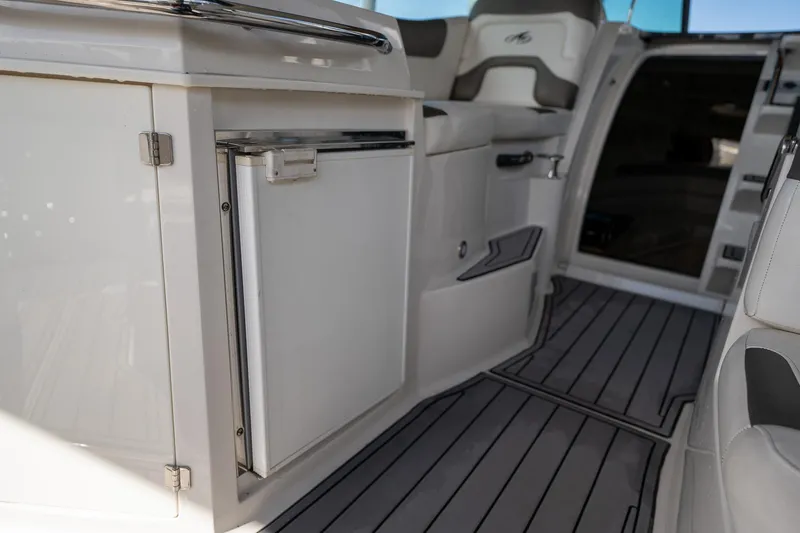 Slide: The Image of 2014 Monterey 295 Sport Yacht interior with sleek cabinetry and seating. - 17