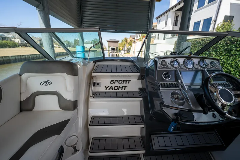 Slide: The Image of 2014 Monterey 295 Sport Yacht interior with helm and seating area. - 19