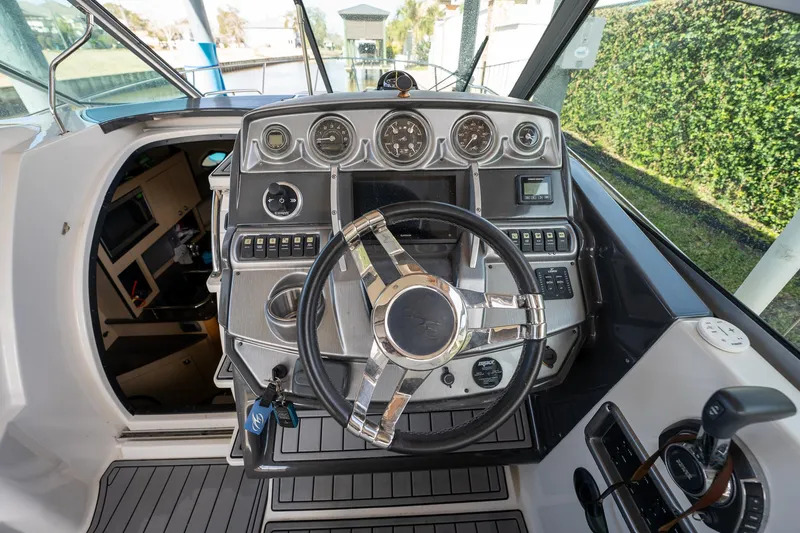 Slide: The Image of 2014 Monterey 295 Sport Yacht dashboard with steering wheel and control panel. - 22