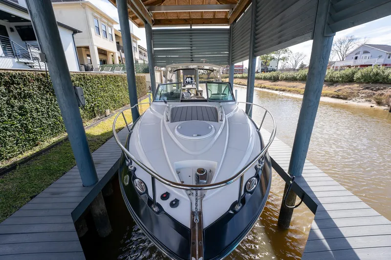 Slide: The Image of 2014 Monterey 295 Sport Yacht docked under a covered slip. - 4