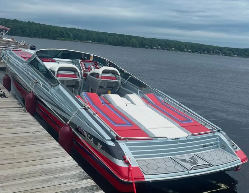 Slide: The Image of 2014 Formula 382 FASTech speedboat docked by a lake, featuring red and white accents. - 12