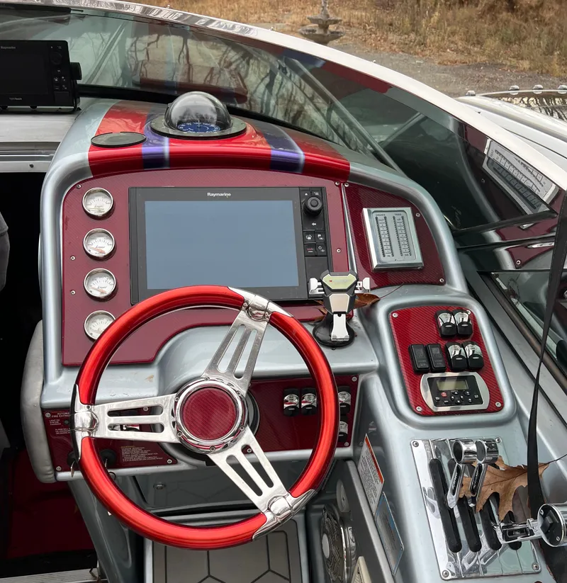 Slide: The Image of 2014 Formula 382 FASTech boat dashboard with red accents and advanced navigation controls. - 13