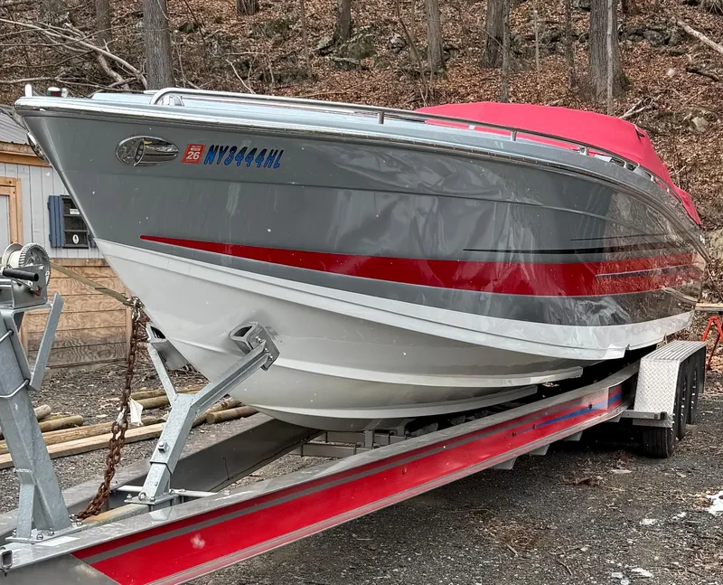 Slide: The Image of 2014 Formula 382 FASTech boat with red and gray design on a trailer. - 5
