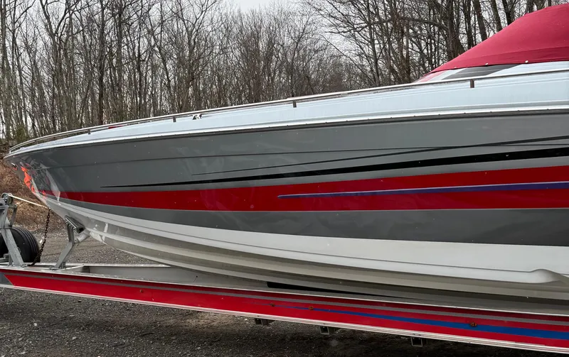 Slide: The Image of 2014 Formula 382 FASTech boat with sleek red and gray design on a trailer. - 6