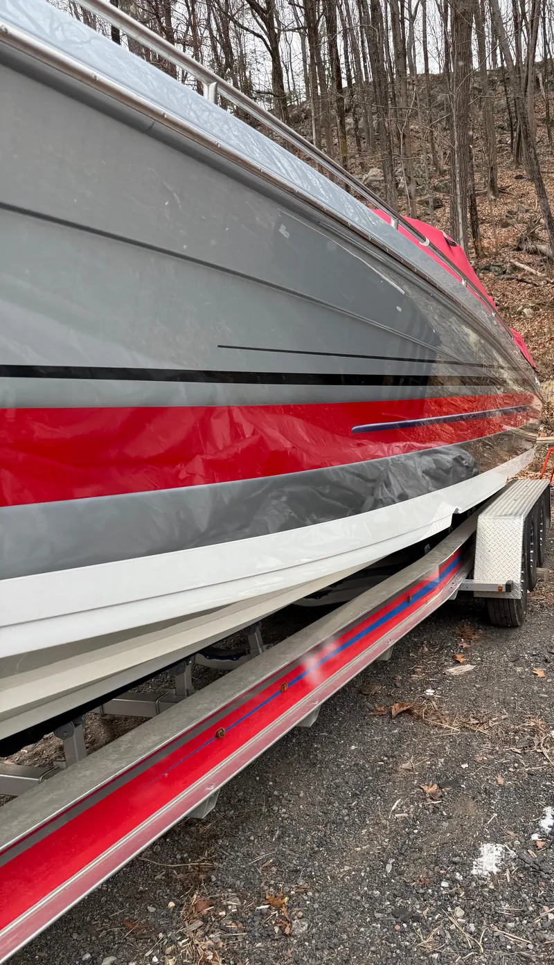 Slide: The Image of 2014 Formula 382 FASTech boat with red and gray hull on a trailer. - 7