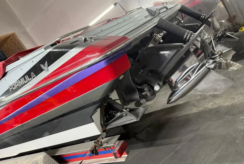 Slide: The Image of 2014 Formula 382 FASTech boat, rear view, showcasing dual propellers and vibrant red and blue accents. - 9