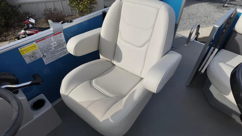 Slide: The Image of 2025 Sylvan MIRAGE 818 CRS boat seat, beige upholstery, armrests, and control panel. - 12